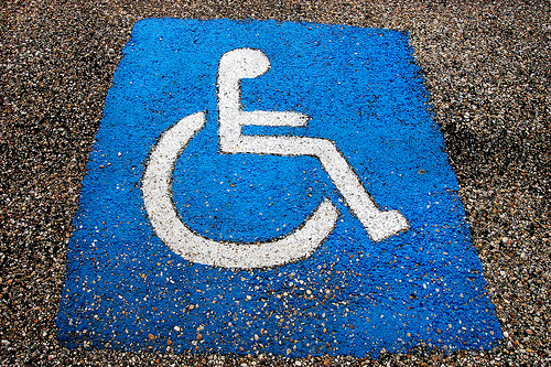 international symbol of accessibility painted on pavement